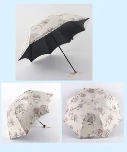 Floral tri-fold sun umbrella with double-layer lace trim and black UV blocking inner lining.