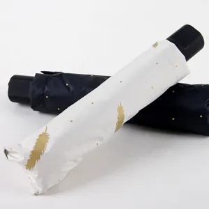 Portable folding sun umbrella with elegant feather pattern, UV protection compact design.