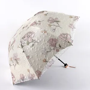 Three-fold sun rain umbrella with double-layer lace embroidery and floral pattern.