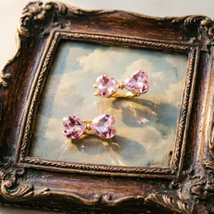 Detail shot of pink crystal heart hair clips with sparkling stones and sweet girlish design.
