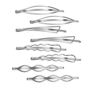Close-up of minimalist silver metal hair clips in various geometric hollow shapes for styling.