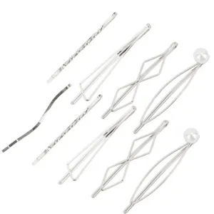 Close-up detail shot of silver metal hair clips set, featuring geometric and pearl designs.