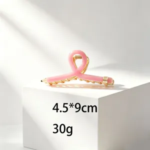Pink pencil hair claw clip for women, creative gold metal half up hair styling accessory.