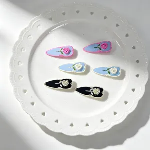 French vintage enamel rose hair clips detail close up, elegant side bobby pins for women and girls.