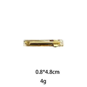 Detailed view of a golden hair clip, showing the exquisite texture and metal surface design.