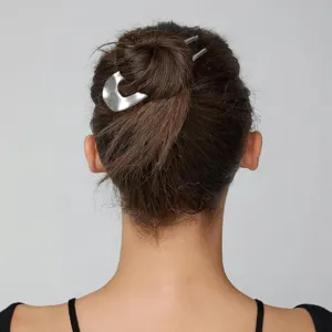 Dettaglio forcina per capelli in metallo argentato minimalista, design moderno per acconciature.