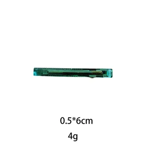 Close-up detail of the transparent green hair clip, showing smooth surface and metal clasp.