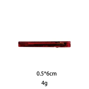 Close-up detail of the red transparent resin hair clip, showing the exquisite texture and size.