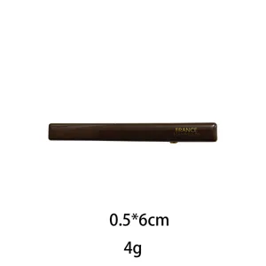 Detailed view of brown rectangular hair clip showing glossy finish and precise size markings.