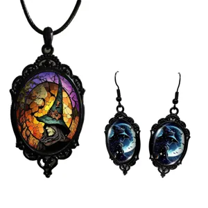 Close-up detail of gothic witch glass cabochon pendant necklace and matching earrings set.