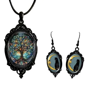 Gothic black vintage jewelry set featuring tree of life pendant and crescent moon cat earrings.