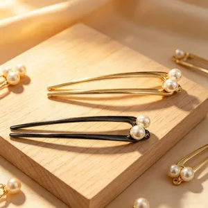 Detail view of elegant U-shaped alloy hairpins with faux pearls, perfect for styling buns.