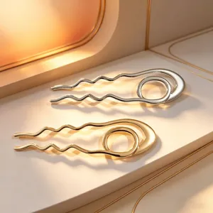 Detailed view of stylish metallic wavy U-shaped hairpins in elegant gold and silver.