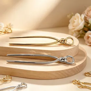 Elegant U-shaped metal hair fork in gold and silver, perfect for stylish hair buns and updos.