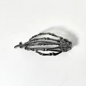 Detailed close-up of a dark metal skeleton hand hair claw clip, perfect for thick hair styling.