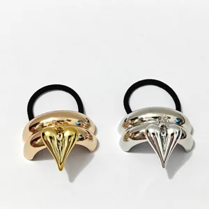 Gold and silver metal curved tube chunky puffy heart pendant hair tie detail view.
