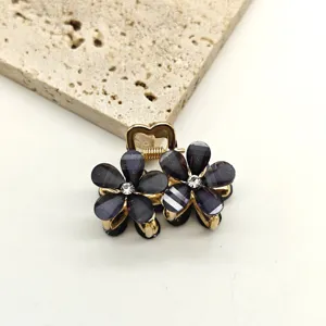 Mini crystal flower hair claw clip, cute dark floral hair accessory for women styling.