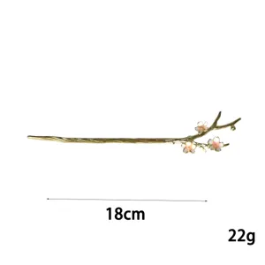 Alloy hair stick detail view featuring a delicate branch design with elegant enamel cherry blossoms.