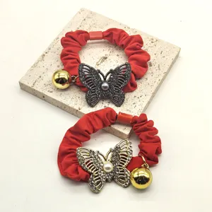 Red rhinestone butterfly hair scrunchies with cute gold bell ponytail holders for women.