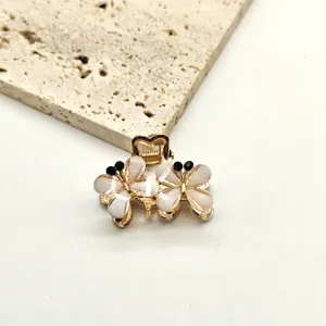 Detailed closeup view of a mini crystal flower hair claw clip, elegant side hairpin accessory.