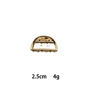 Mini gold metal hair claw clip, geometric half-circle design, elegant hair accessory for women.