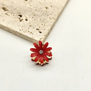 Detailed view of the mini red crystal flower hair claw clip, showing sparkling rhinestone center.
