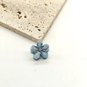 Close-up detail of the mini blue crystal flower hair claw clip, showcasing delicate floral petals.