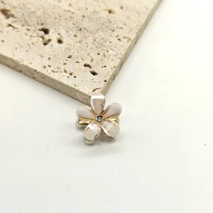Detailed close-up of a mini crystal flower hair claw clip, elegant small side hair accessory.