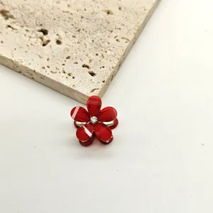 Detailed close-up of a mini red crystal five-petal flower hair claw clip with rhinestones.