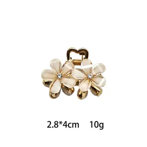 Mini five-petal flower hair claw clip for women, elegant crystal side hairpin with sparkling rhinestones.