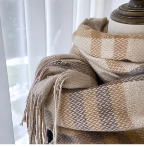 Brown beige plaid winter scarf detail shot showing soft imitation cashmere texture fringe.