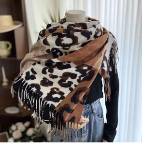 Details of the stylish leopard print colorblock scarf featuring cozy soft texture and tassel trim.