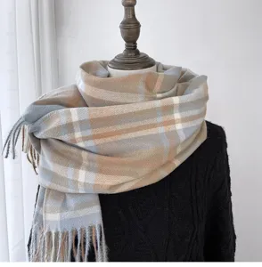 Detail shot of women's autumn winter plaid tassel cashmere feel scarf warm fashion neck wrap.