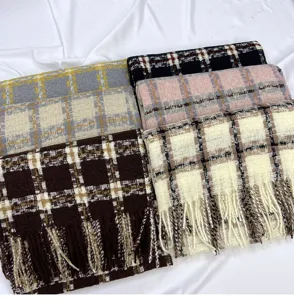Close up of soft autumn and winter plaid scarves with fringe details, warm cashmere feel.