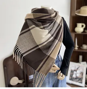 Detailed view of a stylish brown plaid tassel cashmere-feel scarf for women autumn.