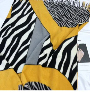 Close-up detail of the geometric zebra print cashmere-feel scarf with stylish color blocks.