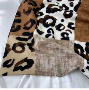 Detail shot of cashmere-feel leopard print patchwork scarf, showcasing soft warm texture.