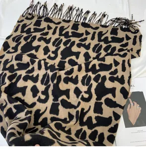 Detail view of winter leopard print imitation cashmere scarf with soft tassel fringe texture.