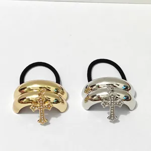 Chic metallic dome hair tie featuring a sparkling rhinestone cross pendant for women and girls.