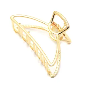 Minimalist hollow gold metal hair claw clip for women, elegant geometric hair accessory.
