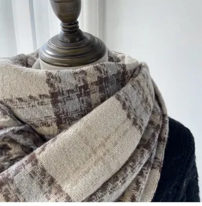 Close-up detail of the stylish plaid imitation cashmere scarf showing soft texture and warm design.