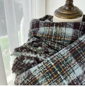 Detailed view of a cozy thickened plaid scarf with vintage pattern, soft texture and warm drape.