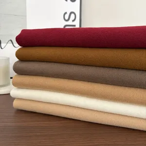 Detailed view of soft solid color imitation cashmere winter scarves stack showing cozy fabric.