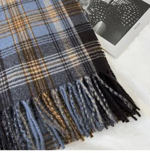 Detailed view of women autumn winter retro plaid scarf with cozy tassels and warm design.