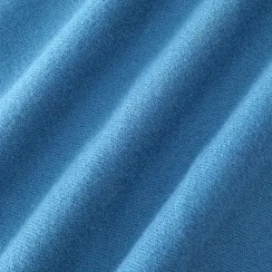 Close-up detail of soft blue faux cashmere fabric scarf texture, cozy winter accessory.