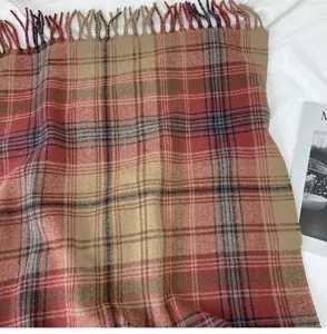 Detail view of a vintage plaid winter scarf with fringe, soft warm shawl for chilly days.