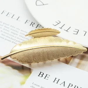 Minimalist zinc alloy leaf hair claw clip, elegant gold metal hair accessory for women.