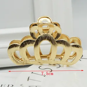 Close-up detail of the elegant golden crown hair claw clip, showing exquisite hollow texture.