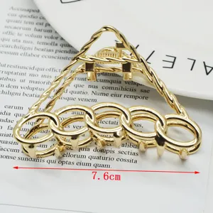 Detailed view of gold zinc alloy hair claw clip, geometric triangle metal hair accessory.