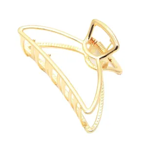 Minimalist gold metal hair claw clip for women, large geometric hair catch accessory for thick hair.